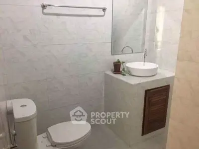 Modern minimalist bathroom with sleek fixtures and white tiles