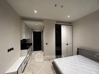 Modern bedroom with sleek design and built-in storage in a contemporary apartment.