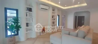 Spacious modern living room with elegant decor and built-in shelves.