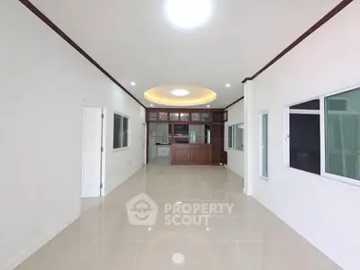 Spacious open-plan living room with modern design and ample natural light.
