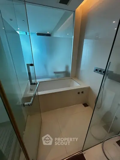 Luxurious modern bathroom with glass shower and elegant bathtub