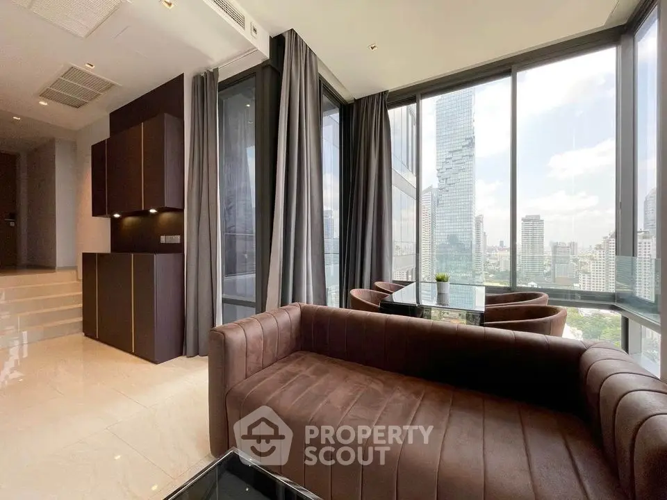 Luxurious high-rise living room with stunning city views and modern furnishings.