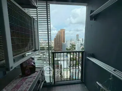 Stunning city view from a modern high-rise balcony with urban skyline.