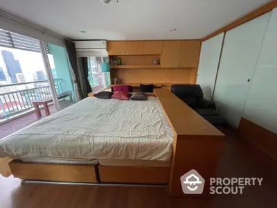 Spacious bedroom with city view and large balcony access