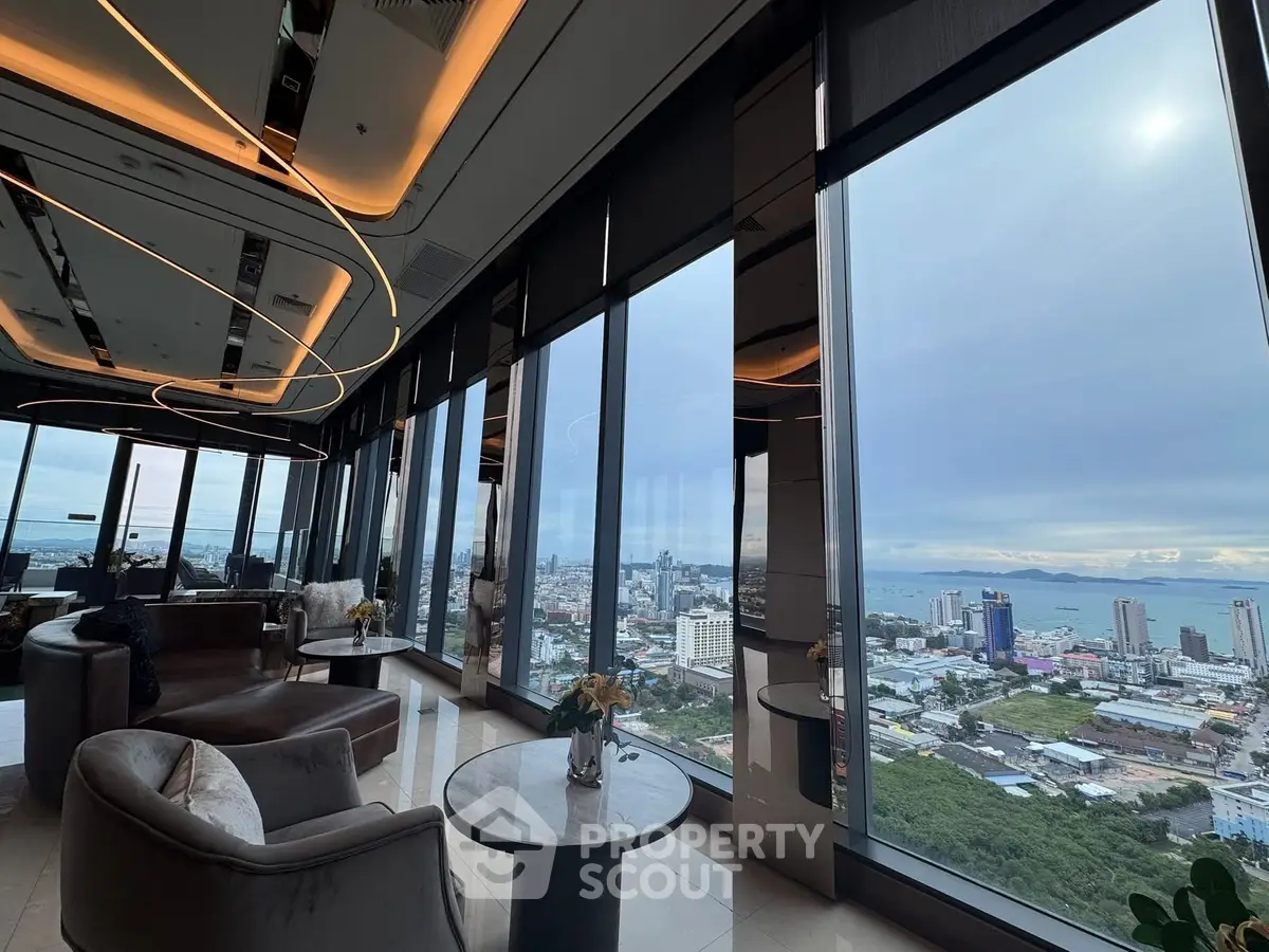 Luxurious high-rise living room with panoramic city and ocean views