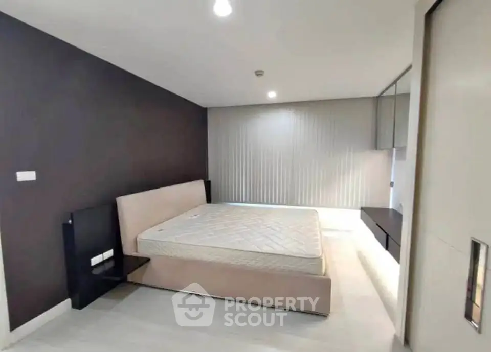 Spacious modern bedroom with sleek design and ample natural light