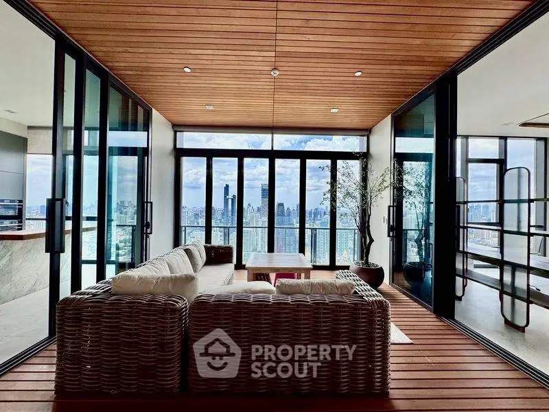 Luxurious living room with panoramic city view and elegant wooden ceiling.