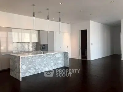 Luxurious modern kitchen with marble island and open layout in spacious apartment