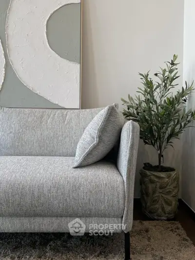 Stylish modern living room with gray sofa and decorative plant