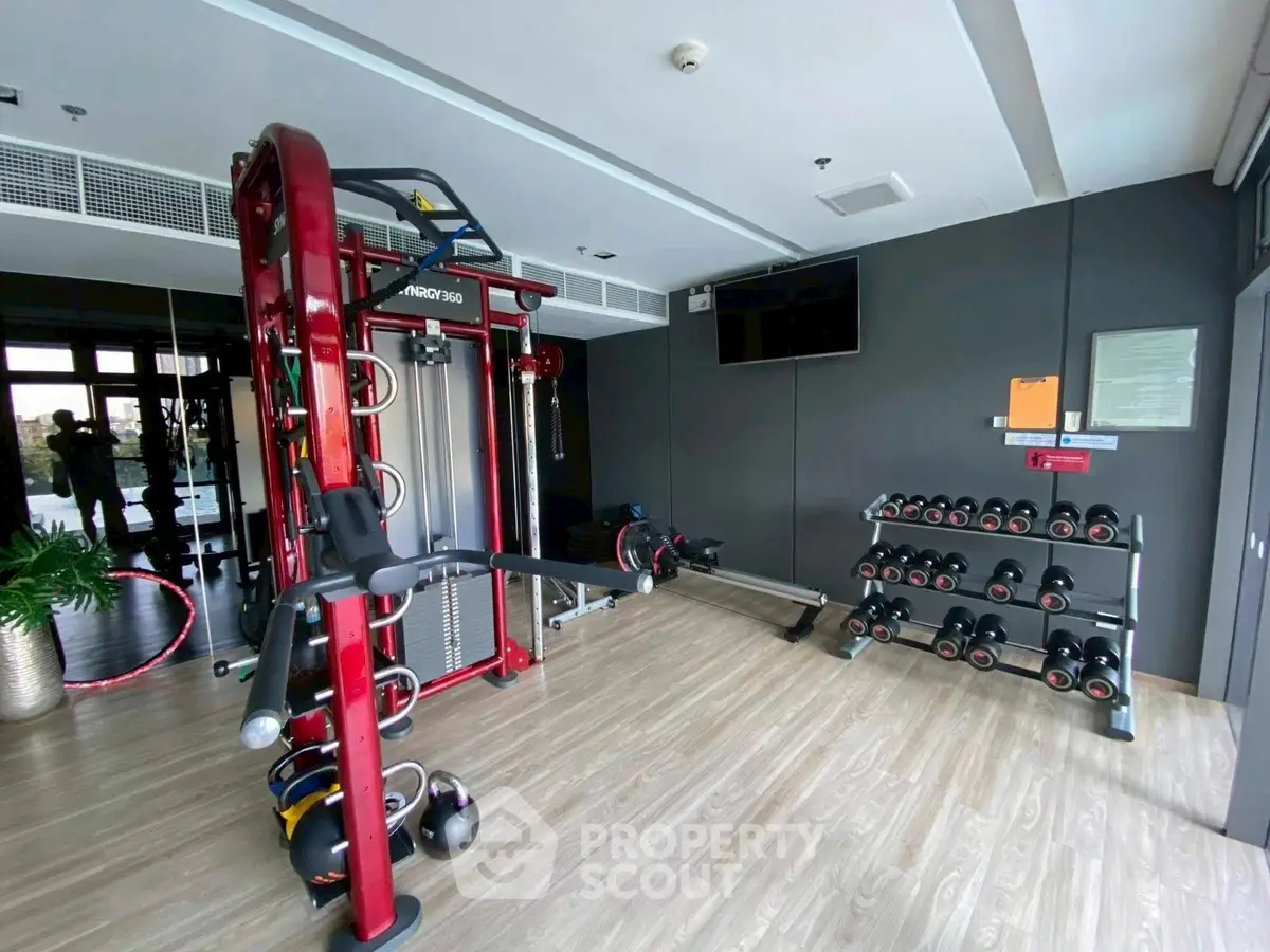 Modern gym with state-of-the-art equipment and sleek design in a residential building.