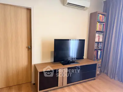 Modern living room with sleek TV stand and air conditioning unit, perfect for cozy entertainment.