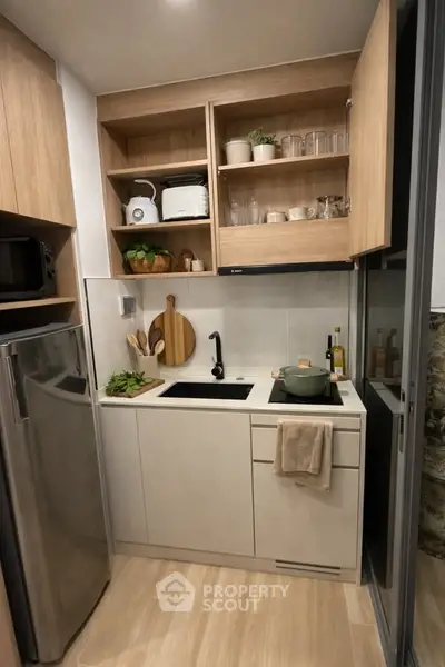 Modern compact kitchen with sleek cabinetry and stainless steel appliances