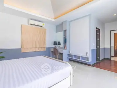 Spacious modern bedroom with stylish decor and natural light