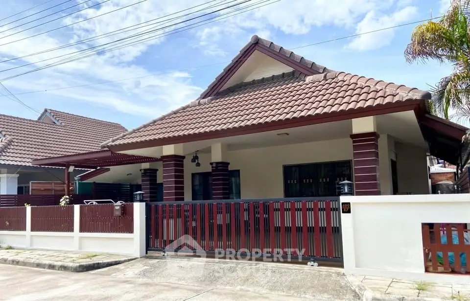 Charming single-story house with tiled roof and spacious front yard in a serene neighborhood.