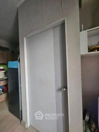 Modern interior with sleek door and organized kitchen storage