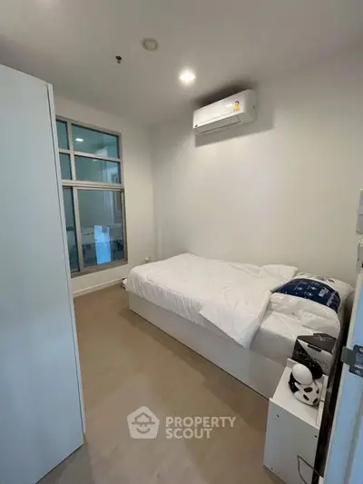 Cozy bedroom with modern air conditioning and minimalist decor