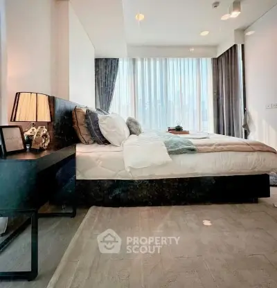 Luxurious bedroom with floor-to-ceiling windows and elegant decor in modern apartment.