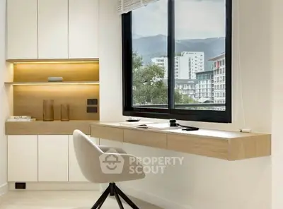 Modern study room with sleek built-in desk and scenic window view in contemporary apartment.