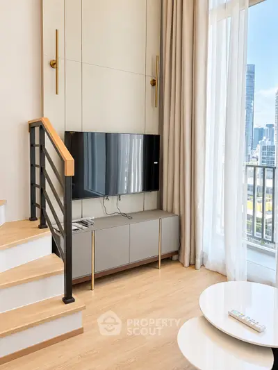 Modern living room with sleek TV setup and city view from large windows