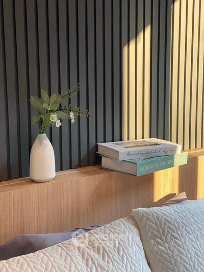 Stylish bedroom with modern decor and cozy pillows, perfect for relaxation.