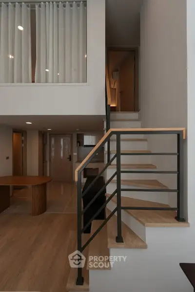 Modern duplex interior with stylish staircase and open layout, perfect for contemporary living.