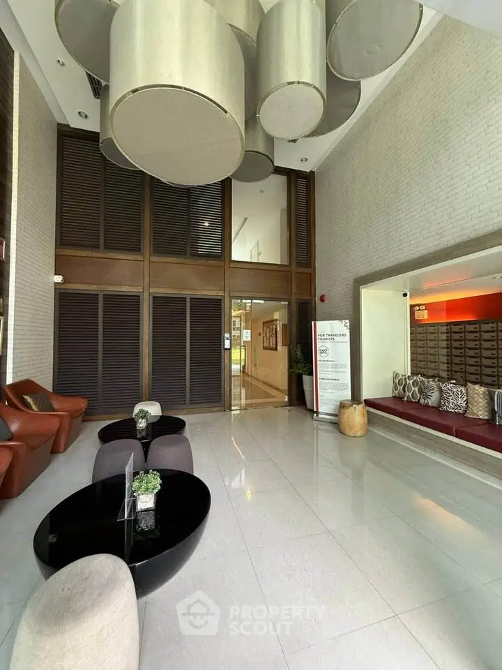 Luxurious modern lobby with stylish seating and unique ceiling decor