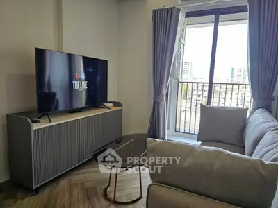 Modern living room with sleek furniture and city view balcony, perfect for urban living.