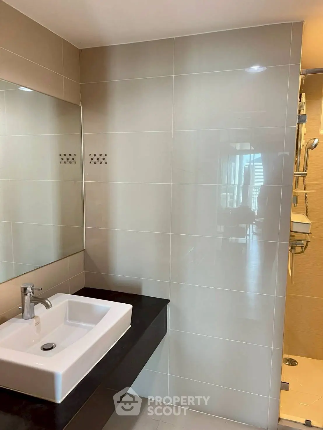 Modern bathroom with sleek sink and glass shower enclosure