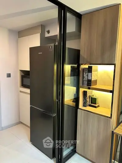 Modern kitchen with sleek black fridge and stylish wooden cabinetry