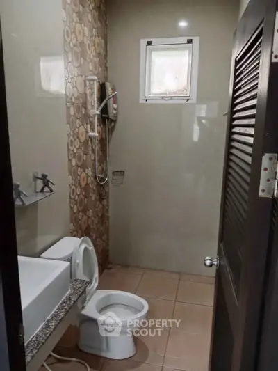 Compact bathroom with modern fixtures and unique wall design
