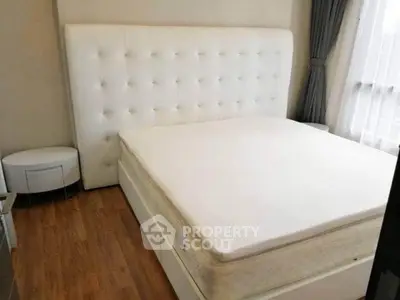 Spacious bedroom with elegant white bed and natural light