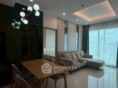 Modern living room with city view, stylish furniture, and elegant lighting in a high-rise apartment.