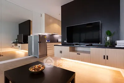 Modern living room with sleek TV setup and stylish kitchen area