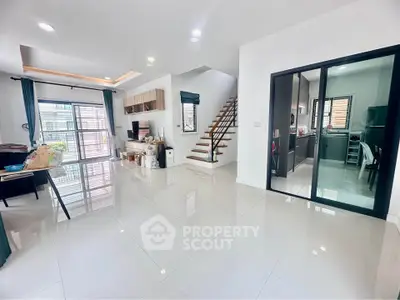 Spacious modern living room with sleek design and open kitchen layout