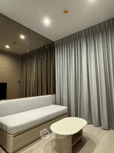 Modern living room with sleek sofa and elegant curtains in a stylish apartment.