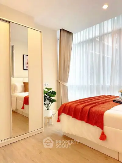 Bright and cozy bedroom with large windows and modern decor