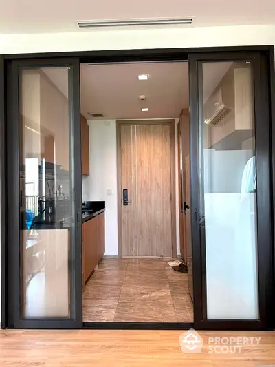 Modern kitchen with sliding glass doors and wooden cabinetry