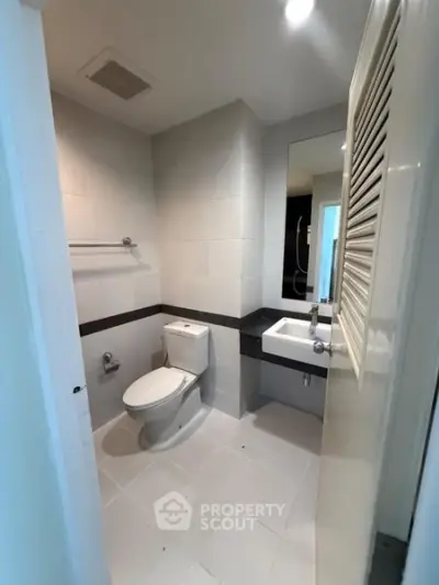 Modern bathroom with sleek white tiles and contemporary fixtures