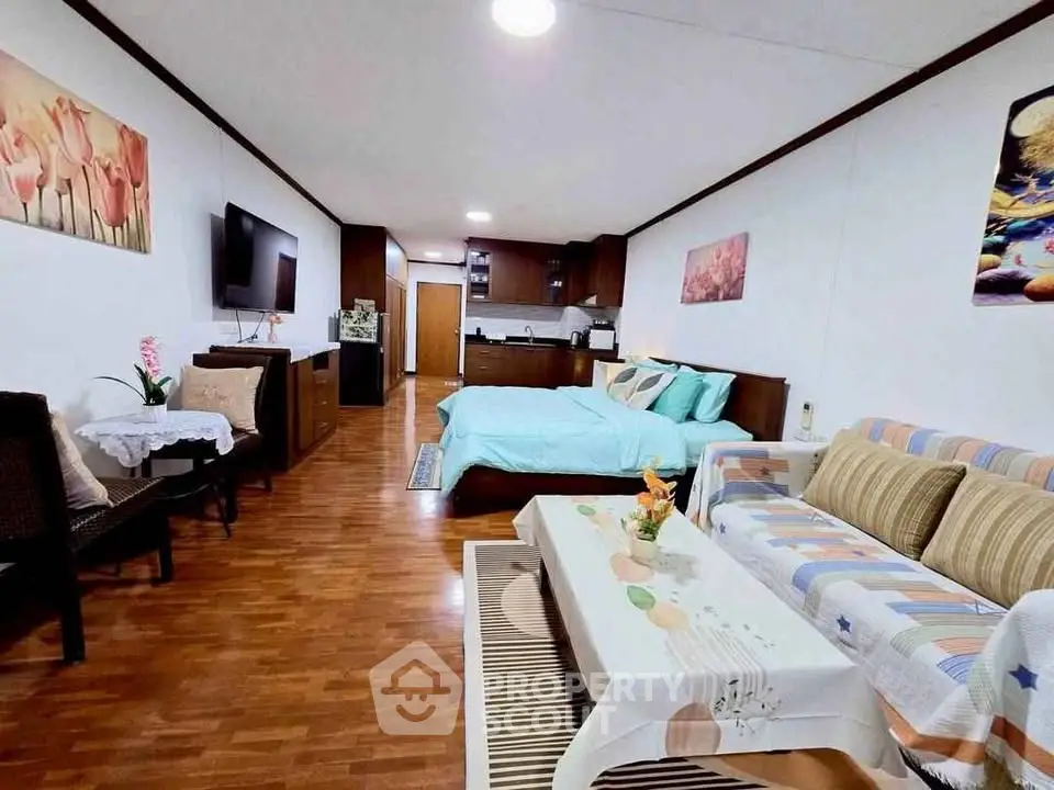 Spacious studio apartment with cozy living area and modern kitchen, perfect for urban living.