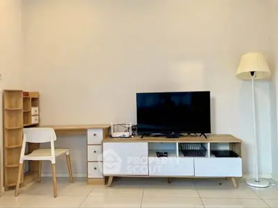 Modern living room with sleek TV stand, desk, and stylish lamp in a minimalist design.