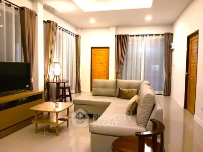 Spacious modern living room with elegant decor and ample natural light