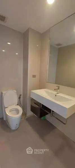 Modern bathroom with sleek fixtures and large mirror