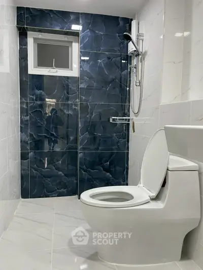 Modern bathroom with sleek blue tiles and white fixtures