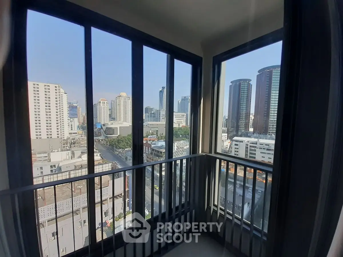 Stunning city view from a modern high-rise balcony with sleek railing design.