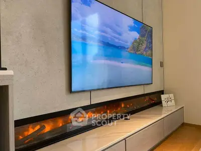 Modern living room with sleek wall-mounted TV and stylish electric fireplace.