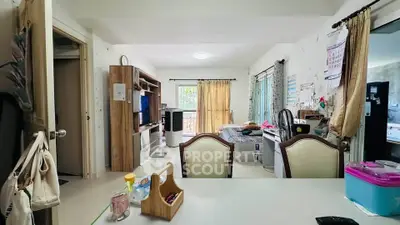 Spacious living area with open layout, featuring a cozy bedroom and modern furnishings, ideal for comfortable living.