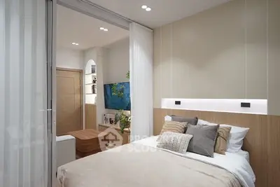 Modern bedroom with cozy decor and sliding glass doors leading to a stylish living area.