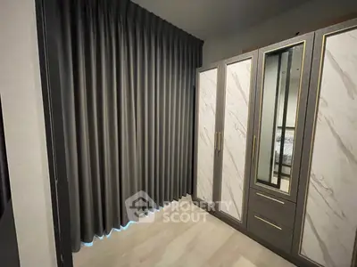 Elegant bedroom with stylish wardrobe and floor-to-ceiling curtains