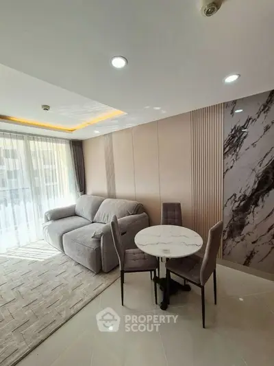 Modern living room with elegant marble accents and cozy seating area