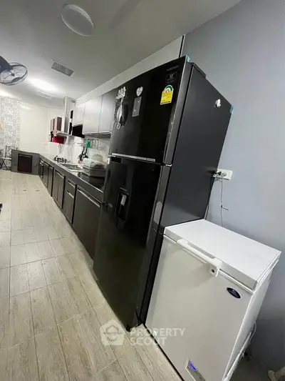 Modern kitchen with sleek black appliances and ample counter space